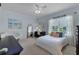 Bright bedroom featuring a white bed, desk, comfortable chair, and soft natural light from the window at 2107 Rickover Pl, Winter Garden, FL 34787