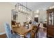 Well-appointed dining room with hardwood floors, large chandelier, and access to the living room at 2107 Rickover Pl, Winter Garden, FL 34787
