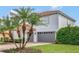 The home features an attached two-car garage, palm trees, and a driveway made of red pavers at 2107 Rickover Pl, Winter Garden, FL 34787