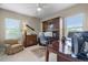 Inviting home office with a large desk, custom wooden cabinets, and natural light from the window at 2107 Rickover Pl, Winter Garden, FL 34787