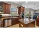 Open kitchen with granite countertops, custom cabinets, stainless steel appliances, and breakfast nook at 2107 Rickover Pl, Winter Garden, FL 34787