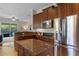 Chef's kitchen featuring stainless steel appliances, custom cabinets, granite counters and center island at 2107 Rickover Pl, Winter Garden, FL 34787