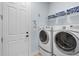 Functional laundry room equipped with modern washer and dryer units and shelving at 2107 Rickover Pl, Winter Garden, FL 34787