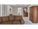 Cozy living room with a comfortable brown couch and a stylish bar area featuring a dark wood cabinet at 2107 Rickover Pl, Winter Garden, FL 34787
