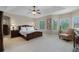 Large bedroom with a tray ceiling, large windows, and a comfortable sitting area at 2107 Rickover Pl, Winter Garden, FL 34787