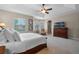 Spacious bedroom featuring a tray ceiling, large windows, and a TV atop a wooden dresser at 2107 Rickover Pl, Winter Garden, FL 34787