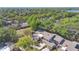 Aerial view featuring townhome roofs surrounded by lush foliage and distant water views at 218 Nettlewood Ln, Fern Park, FL 32730