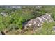 Aerial view showcases the community's lush landscaping and proximity to a beautiful lake at 218 Nettlewood Ln, Fern Park, FL 32730