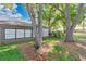 Backyard with a view of the home exterior, large trees, and green grass at 218 Nettlewood Ln, Fern Park, FL 32730