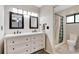Bright bathroom featuring a double sink vanity with framed mirrors, shower and toilet at 218 Nettlewood Ln, Fern Park, FL 32730
