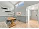 Cozy dining area featuring a modern table, stylish chairs, floating shelves, and convenient kitchen access at 218 Nettlewood Ln, Fern Park, FL 32730