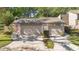 Double garage with concrete driveway, American flag, landscaping, and partial sidewalk at 218 Nettlewood Ln, Fern Park, FL 32730