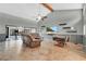 Spacious living room featuring a modern ceiling fan, sleek shelves, and sliding glass doors to the exterior at 218 Nettlewood Ln, Fern Park, FL 32730