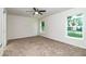 Bright, carpeted bedroom with neutral walls, ceiling fan, and large windows at 22 Laurel Crse, Ocala, FL 34480