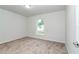 Light-filled bedroom with a window offering a view of the neighborhood and plush carpet at 22 Laurel Crse, Ocala, FL 34480
