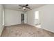 Carpeted bedroom featuring a ceiling fan and connected to an ensuite bathroom at 22 Laurel Crse, Ocala, FL 34480