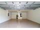 Spacious two-car garage featuring epoxy flooring and ample storage at 22 Laurel Crse, Ocala, FL 34480