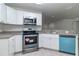 Modern kitchen with stainless steel appliances, light countertops and white cabinets at 22 Laurel Crse, Ocala, FL 34480