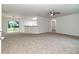 Bright, carpeted living room with open concept to the kitchen and rear patio access at 22 Laurel Crse, Ocala, FL 34480
