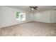 Spacious living room with neutral carpet, ceiling fan, and ample natural light at 22 Laurel Crse, Ocala, FL 34480