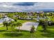 Beautiful view of the community amenity center featuring a sand volleyball court, palm trees and manicured lawn at 2352 Zaballina Pl, Kissimmee, FL 34747