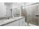 This bathroom features double sinks, granite countertops, and a glass shower at 2352 Zaballina Pl, Kissimmee, FL 34747