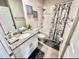 Cozy bathroom featuring granite countertops, stylish decor, and a shower with a decorative curtain at 2352 Zaballina Pl, Kissimmee, FL 34747
