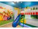 Fun themed bedroom with bunk beds, a slide, and colorful character mural art on the wall at 2352 Zaballina Pl, Kissimmee, FL 34747