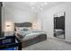 Bedroom featuring a large gray headboard bed, modern light fixture, large mirror and gray carpets at 2352 Zaballina Pl, Kissimmee, FL 34747