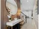 Chic entryway showcasing modern decor, a round mirror, and a staircase leading to the upper level at 2352 Zaballina Pl, Kissimmee, FL 34747