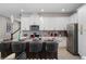 Modern kitchen features granite countertops, stainless steel appliances, white cabinets, and barstool seating at 2352 Zaballina Pl, Kissimmee, FL 34747