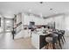 Bright kitchen with stainless steel appliances, granite countertops, stylish bar stools, and modern lighting at 2352 Zaballina Pl, Kissimmee, FL 34747