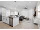 Bright, open-concept living space features tile flooring, modern lighting and a large gray sofa at 2352 Zaballina Pl, Kissimmee, FL 34747