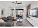 This living room features a large sectional sofa, white shelving, and sliding doors to the back patio at 2352 Zaballina Pl, Kissimmee, FL 34747