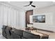 Comfortable living room with a large TV, modern decor, and plush gray sofa at 2352 Zaballina Pl, Kissimmee, FL 34747