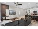 Inviting open-concept living area with a stylish gray sofa, media center, and an adjacent kitchen at 2352 Zaballina Pl, Kissimmee, FL 34747