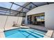 This home's pool has steps and an adjacent seating area with a patio dining table at 2352 Zaballina Pl, Kissimmee, FL 34747