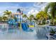 Vibrant community splash pad with water features, slides, and lounge chairs offering fun for all ages at 2352 Zaballina Pl, Kissimmee, FL 34747