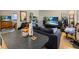 Open concept living space next to kitchen with a large TV and comfortable couch at 2507 E Central Blvd # 21, Orlando, FL 32803