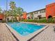 Beautiful community pool surrounded by lush landscaping at 2507 E Central Blvd # 21, Orlando, FL 32803