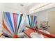Bright bathroom with a colorful shower curtain and a large mirror over the sink at 2622 Jennifer Dr, Lakeland, FL 33810
