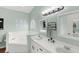 Stylish bathroom with dual vanities, a soaking tub, and elegant fixtures for a spa-like experience at 2622 Jennifer Dr, Lakeland, FL 33810