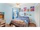 Light blue bedroom featuring a ceiling fan, window, closet, and gaming-themed decor at 2622 Jennifer Dr, Lakeland, FL 33810