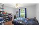 This bedroom features grey walls, a ceiling fan, a window, and arcade and gaming decor at 2622 Jennifer Dr, Lakeland, FL 33810