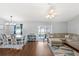 Spacious living room area with hardwood floors, ceiling fan, and sliding glass door at 2622 Jennifer Dr, Lakeland, FL 33810
