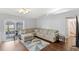 Open living room with a large sectional couch and sliding glass doors leading to the backyard at 2622 Jennifer Dr, Lakeland, FL 33810