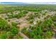 An aerial view showcases the home's neighborhood with tree-lined streets at 304 Woods Landing Dr, Lady Lake, FL 32159