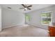 Neutral bedroom featuring two large windows offering plenty of natural light and carpeted flooring at 304 Woods Landing Dr, Lady Lake, FL 32159