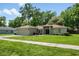 Exterior view of the home showing its manicured lawn and tidy landscaping at 304 Woods Landing Dr, Lady Lake, FL 32159