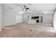 Open living room with neutral carpet, ceiling fan, and bright natural light at 304 Woods Landing Dr, Lady Lake, FL 32159